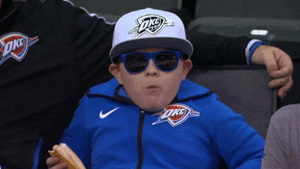 Kid Chewing in a Stadium